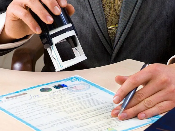 A person stamping on certificate